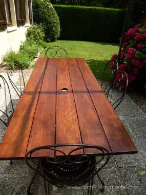 Table en fer-forgé et plateau en bois cumaru ayant plus de 10 ans - entretenu tous les 3 ans avec une lazure spéciale bois exotique table de jardin en bois exotique